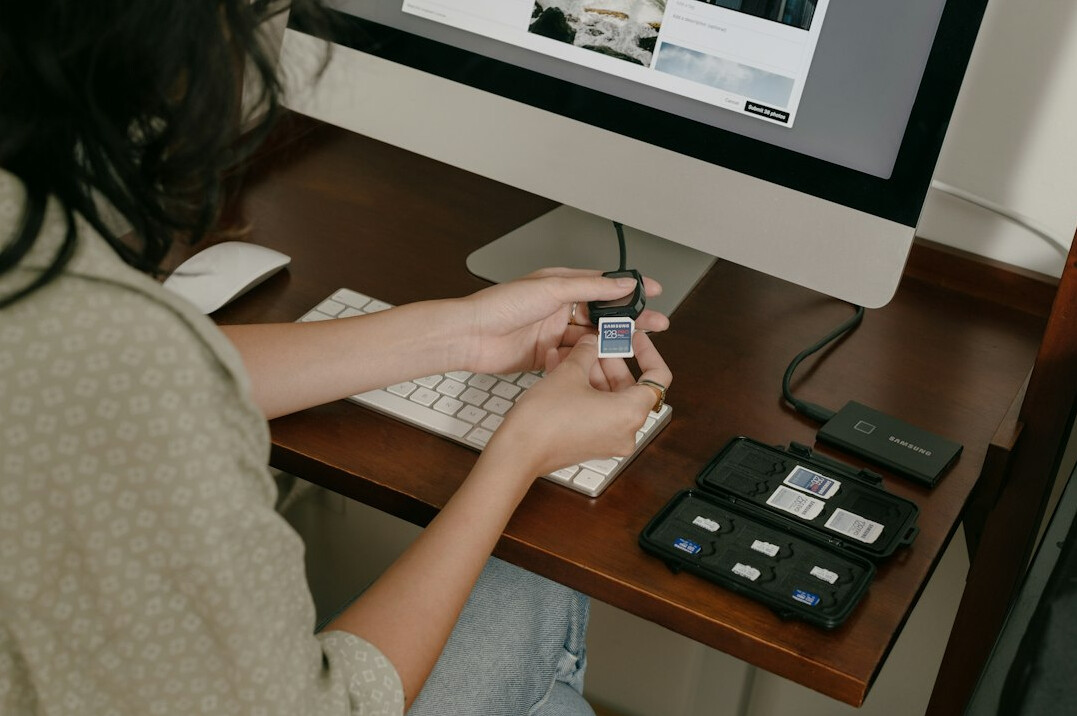 Person editing archival video footage on a computer